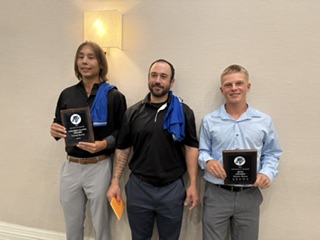Hunter Bruce, a teammate and their coach holding 2025 MVP plaques